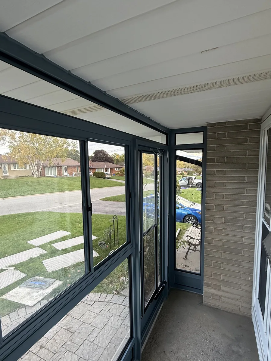 Inside the finished Wedgewood Blue porch enclosure, looking out through the new glass panels to the street
